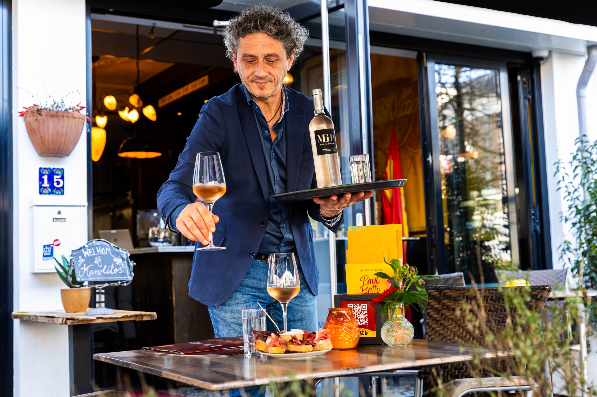 Rosé wordt geserveerd aan een gast op het terras